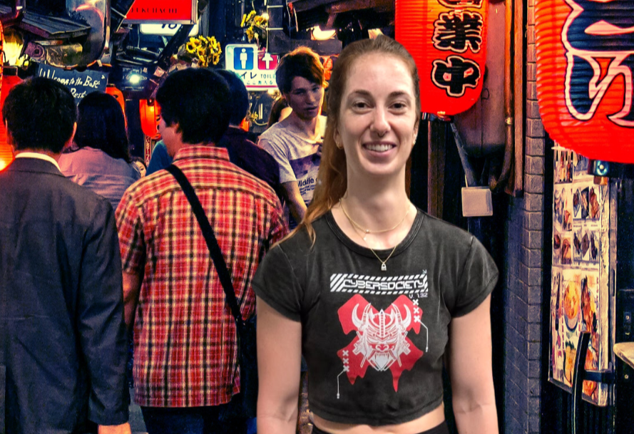 Woman standing in a busy street with colorful signs and lanterns